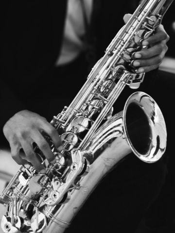 a-person-plays-a-saxophone-.jpg A person plays a saxophone.
